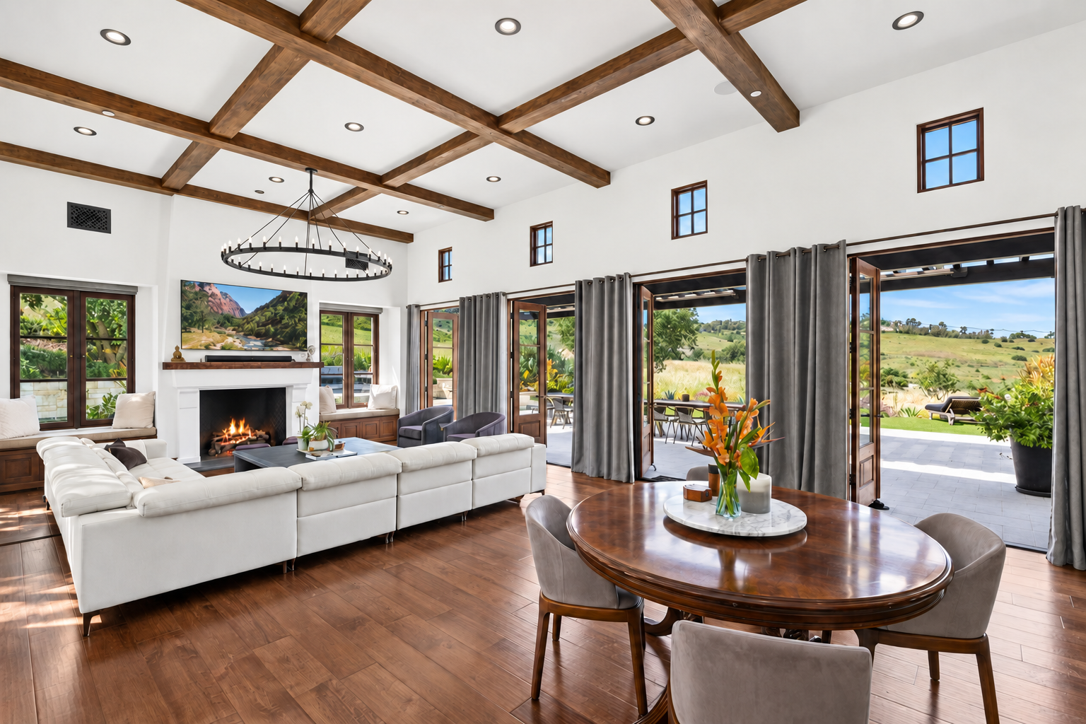 Completed living room with exposed wood beams and garden views — After