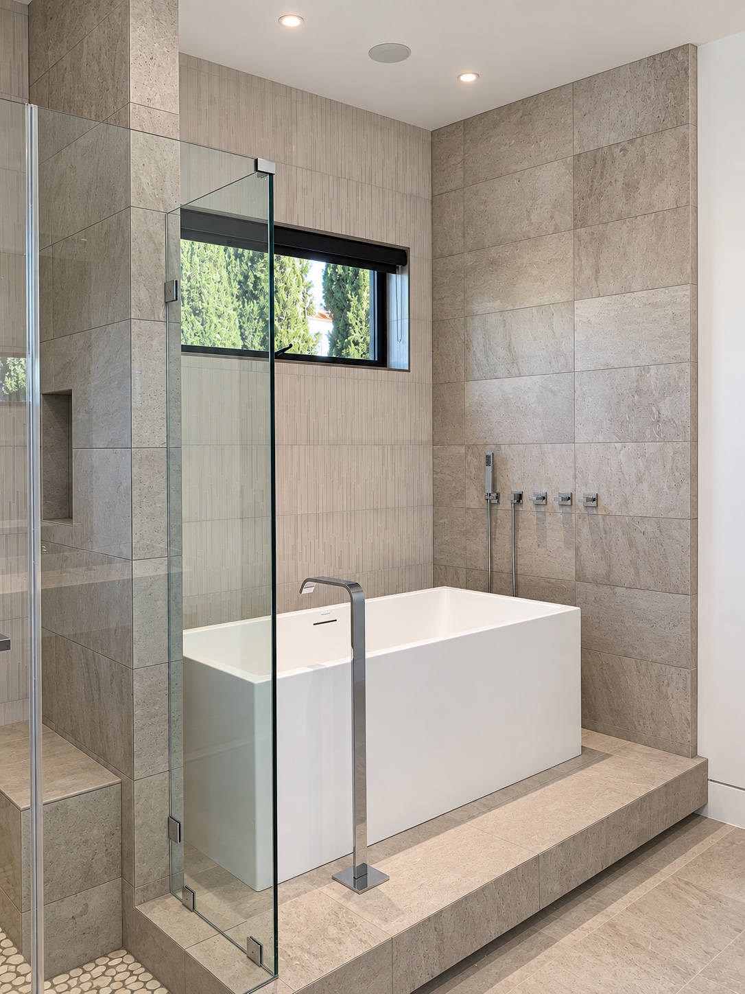 A sculptural soaking tub framed by textured stone in Diamond Bar, CA