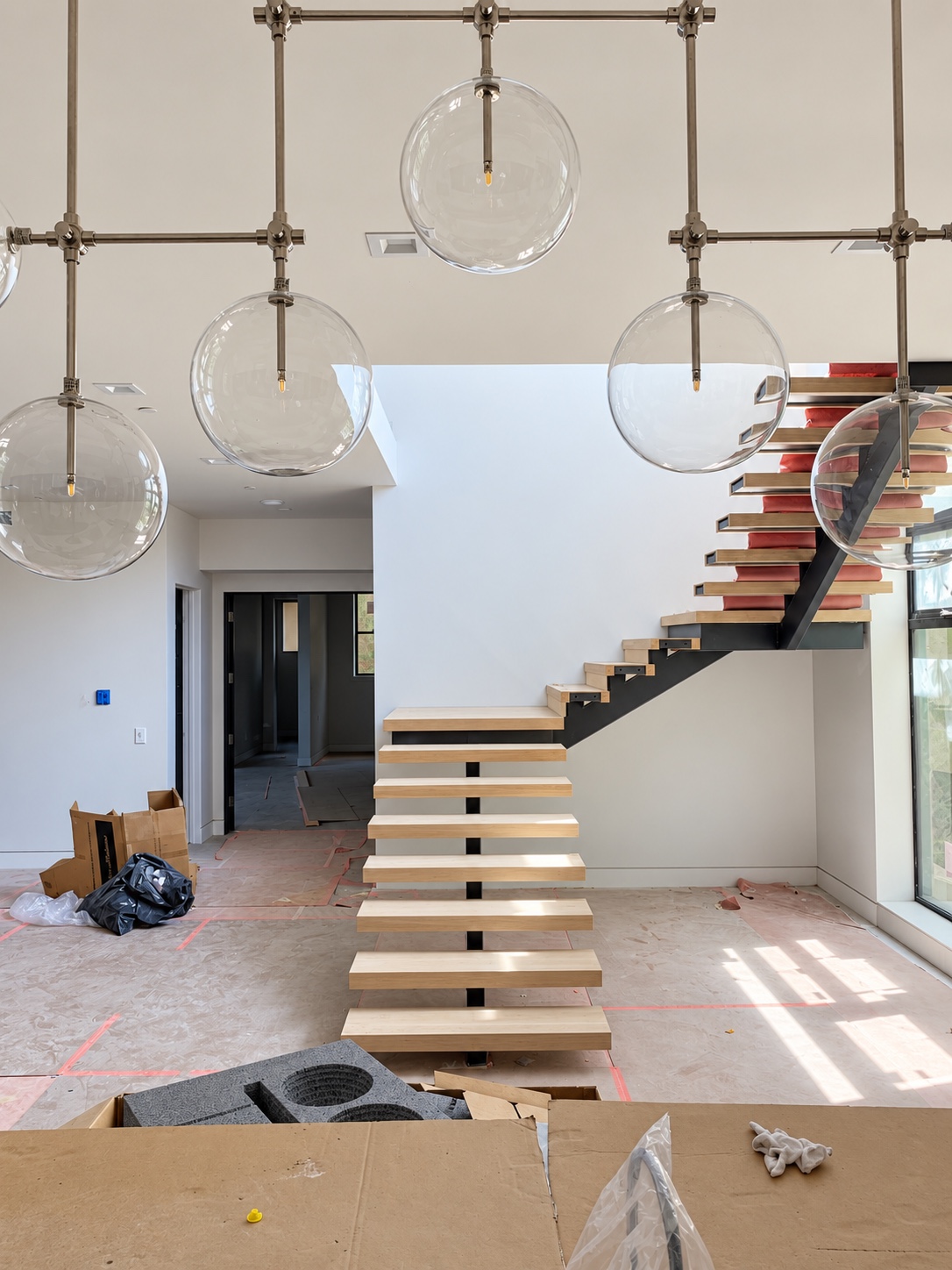 Wood treads installed on a steel stair beneath glass globe lighting — Diamond Bar, CA